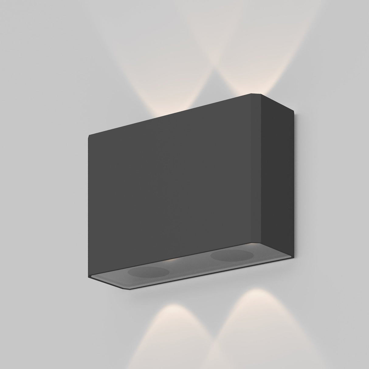 The Show Outdoor Wall Light 3000K in graphite is a modern rectangular wall sconce with an aluminum black matte finish. Mounted to a light-colored wall, this energy-efficient LED design emits soft, intersecting beams both upwards and downwards.