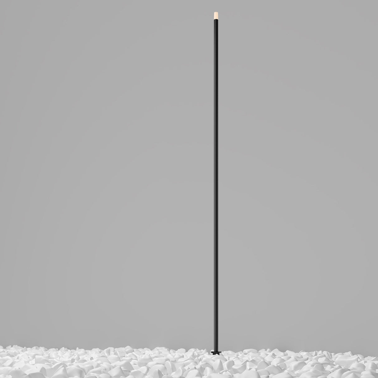 The Spear Outdoor Large Spike Light 3000K 1W in Graphite stands upright among crumpled white paper against a plain gray background.