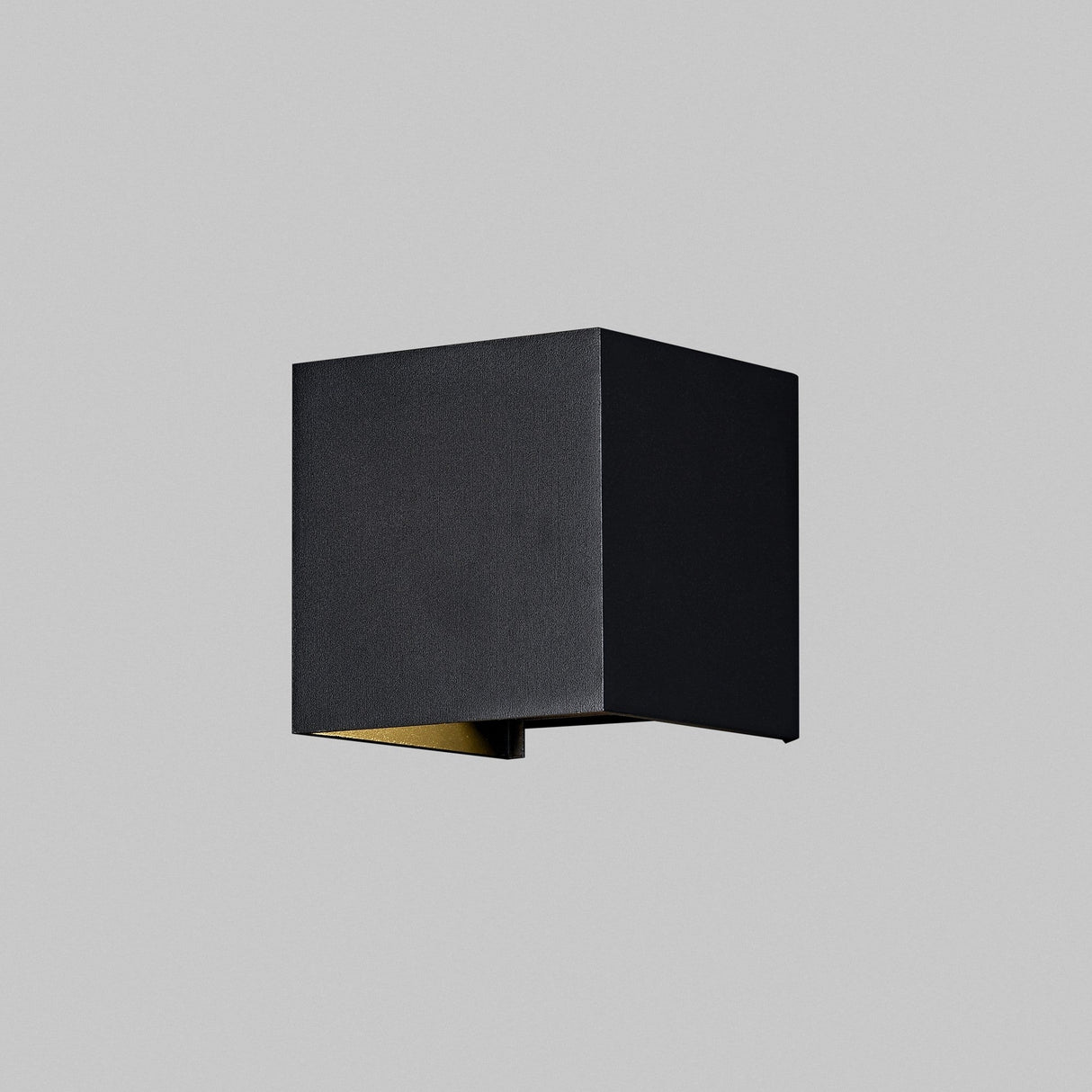 The Fulton Outdoor LED Rectangular Wall Light in black features a minimalist cube shape crafted from corrosion-resistant aluminum, elegantly contrasting against a plain gray background for adjustable outdoor lighting functionality.