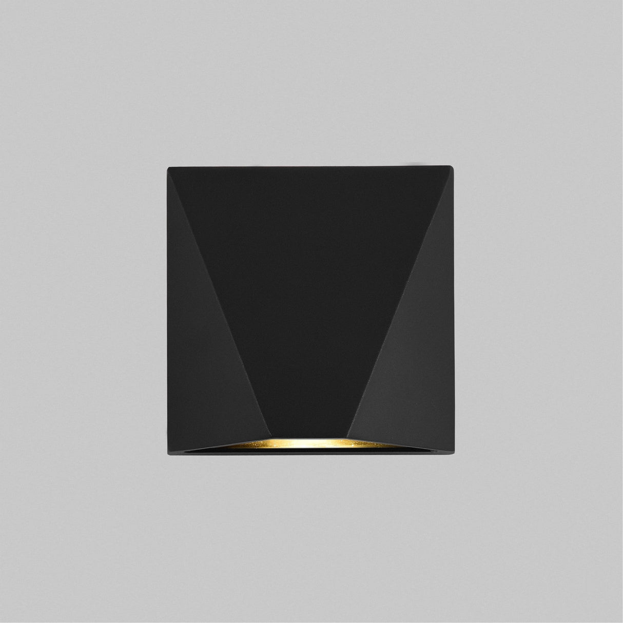 The Beekman Outdoor LED Wall Light 3000K - Black features a sleek, minimalistic, triangular design with an LED emitting from the bottom. Its mounted on a light gray wall and offers IP54-rated protection for outdoor use, perfect for modern aesthetics.