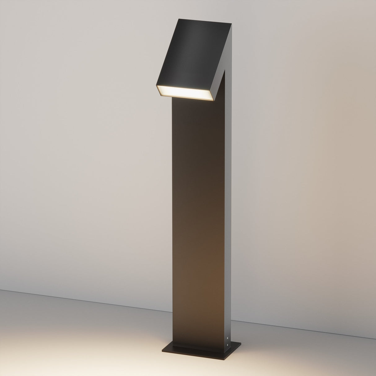 The Guss LED Bollard Light 90cm in graphite has a sleek design with a slanted top, emitting bright LED light. It stands on a flat base against a neutral backdrop and is IP65-rated for outdoor durability, making it ideal for illuminating any space.