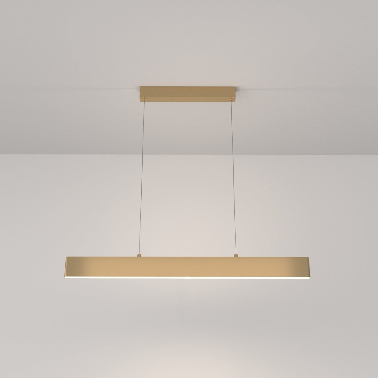 The Step LED Linear Suspension Light 4000K 30W in gold features a minimalist rectangular design, suspended by two thin wires. Designed for energy-efficient illumination, it enhances a modern aesthetic while providing even lighting.