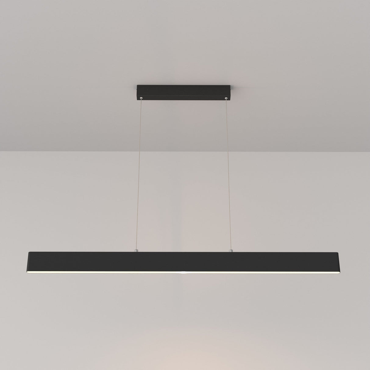 The Step LED Long Linear Suspension Light 3000K 30W features a minimalist black rectangular design that suspends from the ceiling by two thin cables. Using SMD LED technology, it emits a soft downward glow, contrasting beautifully against plain white ceilings and walls.