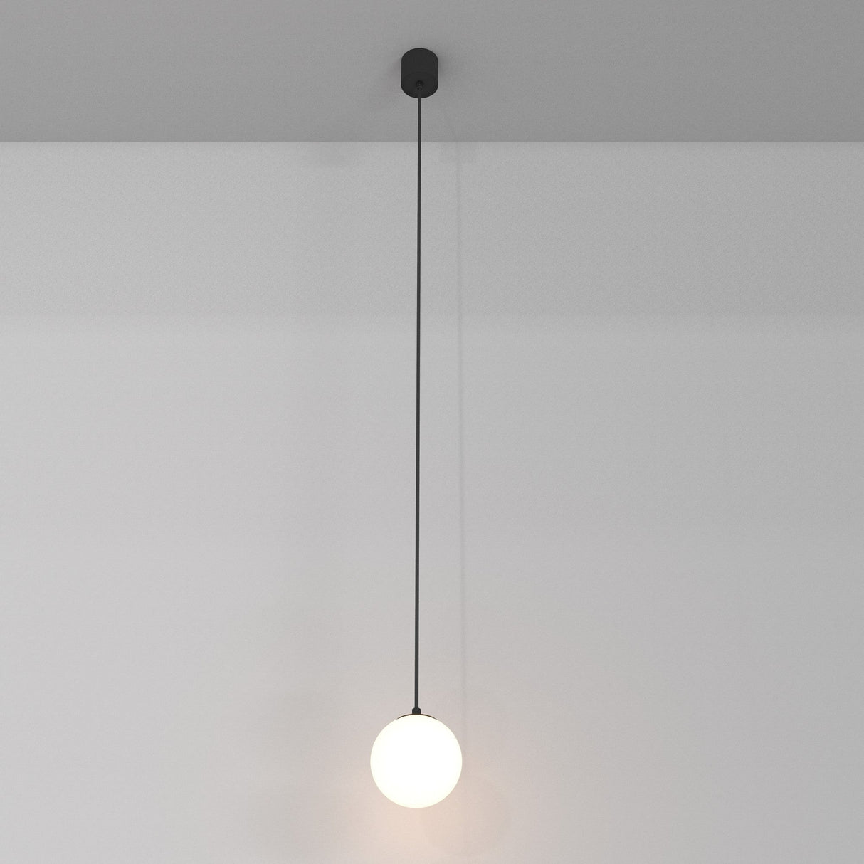 The Luna LED Globe Pendant Light (10cm, 3000K) casts a soft glow with its minimalist black cable and round bulb, offering sleek modern elegance and energy efficiency.