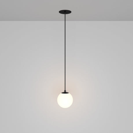 The Luna LED Recessed Globe Pendant Light 10cm 3000K in black and white showcases a minimalist black cord design with a spherical white lampshade, providing a soft glow and energy efficiency against a neutral gray background.