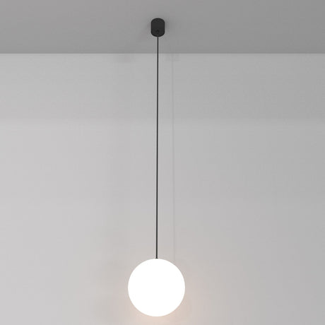 The Luna LED Globe Pendant Light 20cm 3000K - Black & White hangs from a thin black cord, showcasing an energy-efficient white sphere. It contrasts against a gray ceiling and white wall, ideal for modern interiors.
