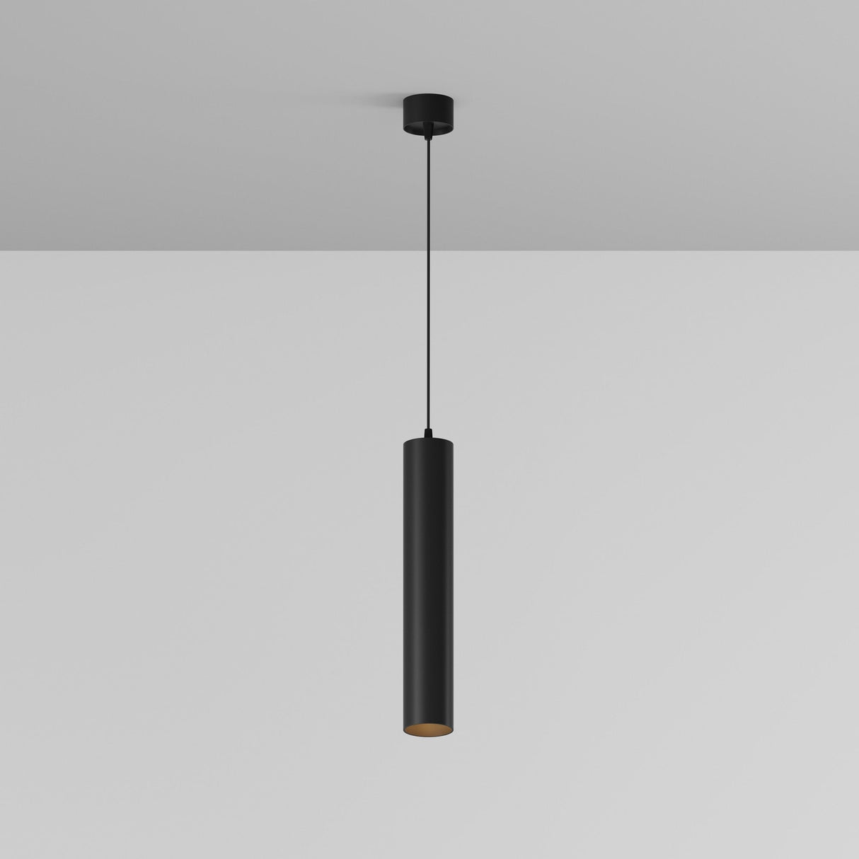 The Focus LED Pendant Light 3000K in Black, featuring a sleek and minimalist cylindrical design, hangs from the ceiling on a black cord against a plain white background, highlighting its energy-efficient lighting.