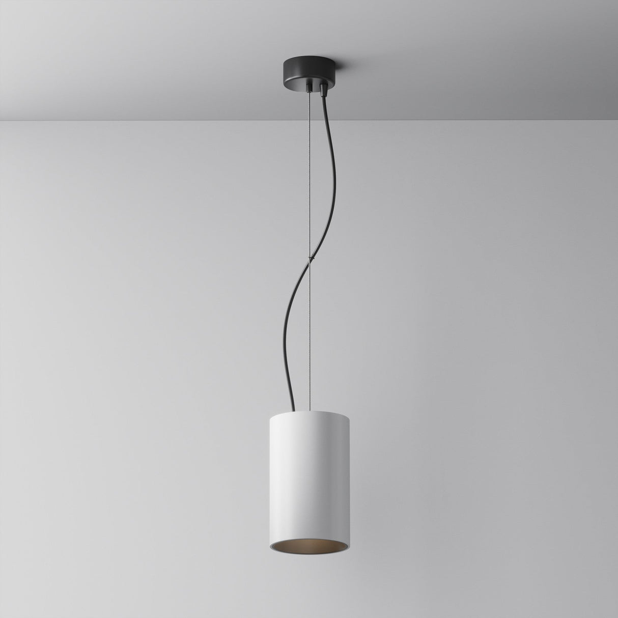The Efir LED Pendant Light 33W - White features a modern cylindrical design with a white shade and black cord, offering energy efficiency and minimalist style that contrasts elegantly against a smooth white wall.