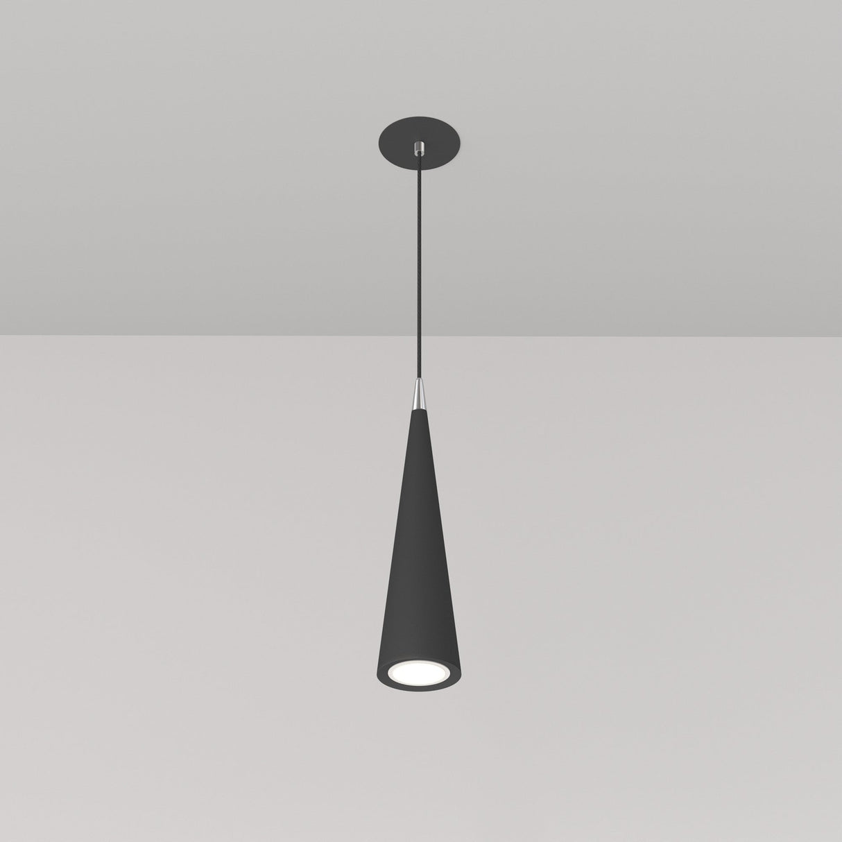 The Nevill Conical Pendant Light - Black hangs elegantly with a sleek cone shape and matte black finish. Its minimalist design includes a thin cord connecting it to a round base, casting a soft, focused downward glow.