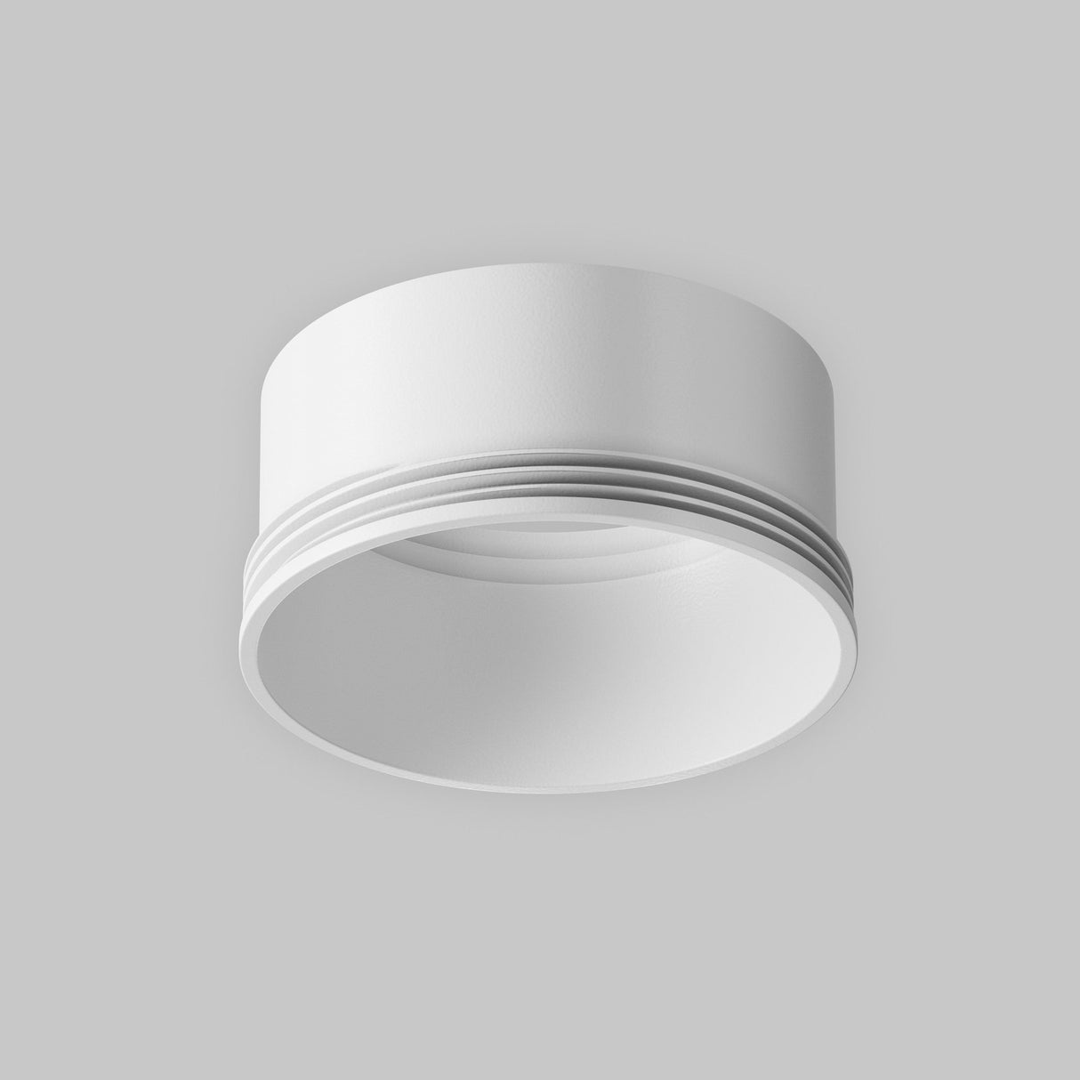 A sleek white Focus LED Medium Decorative Ring for Track Spotlight with layered grooves is shown against a gray background. Its modern, minimalist design and smooth, clean lines make it perfect for any contemporary lighting setup.