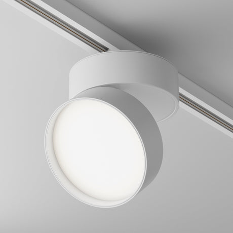 Close-up of the Onda LED Single Phase Unity Track Spotlight in white, featuring an adjustable head and sleek circular design. The 18W light emits a soft 4000K glow along the ceiling-mounted linear track.