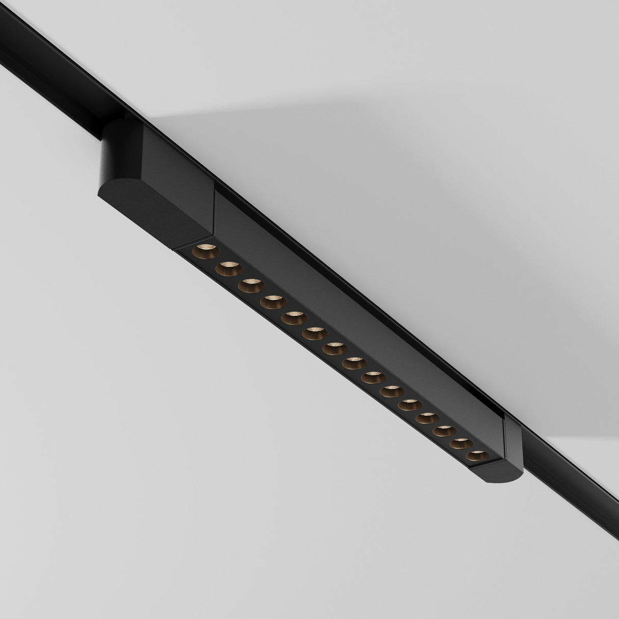 The Points Rot LED Swivel Linear Track Light emits a 22W warm 3000K glow, featuring a minimalist, modern design with multiple small lights on a black fixture mounted on a white ceiling.