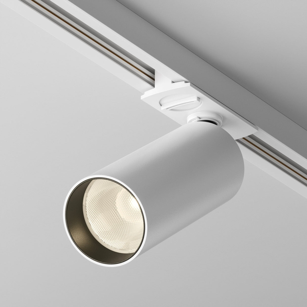 Focus LED single phase Unity track spotlight in white, emphasized for wide lighting coverage in modern setups.