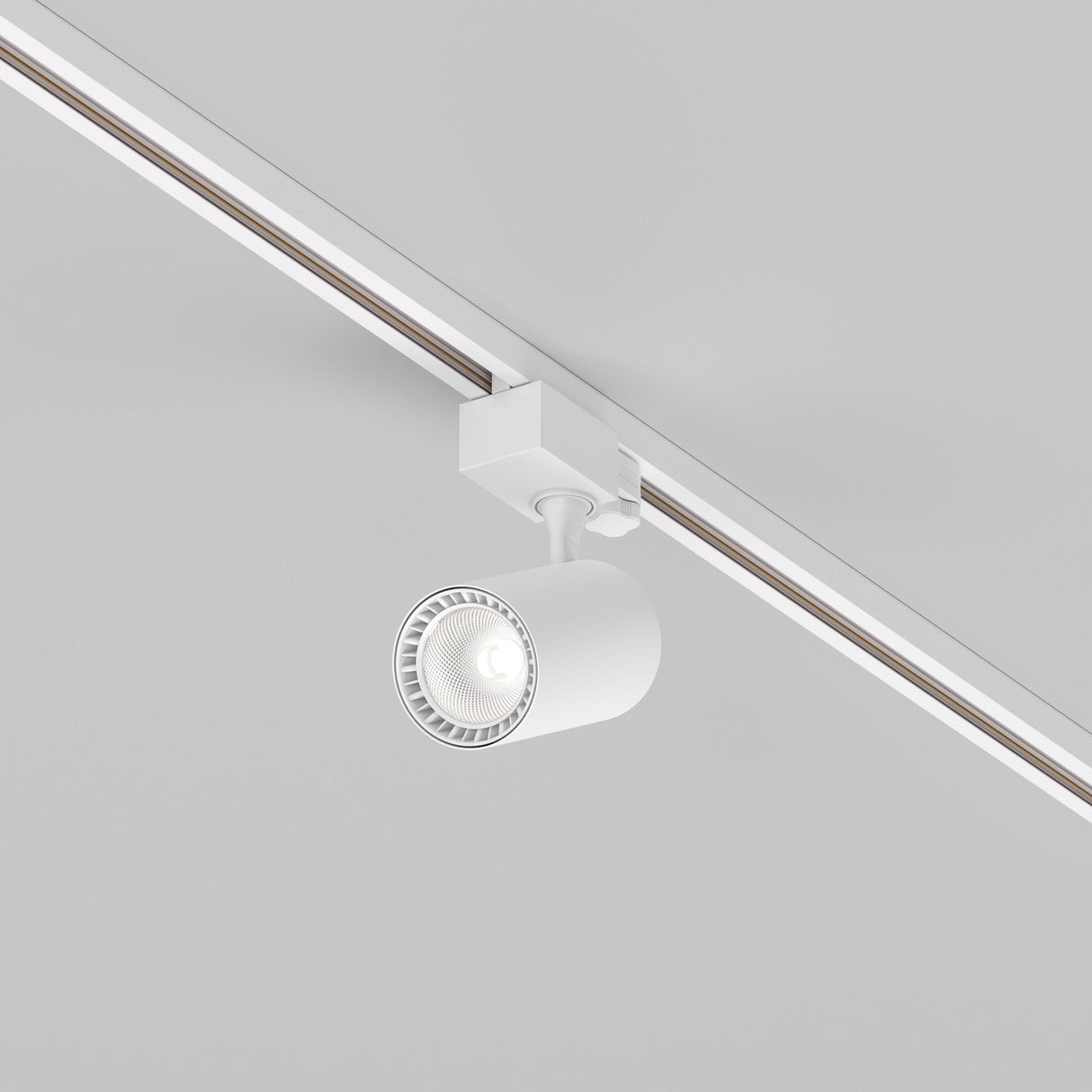 The Vuoro S 3-Circuit Trinity Track LED Spotlight 10W 4000K in white is mounted on a track, illuminating the light gray ceiling with precise directional control.