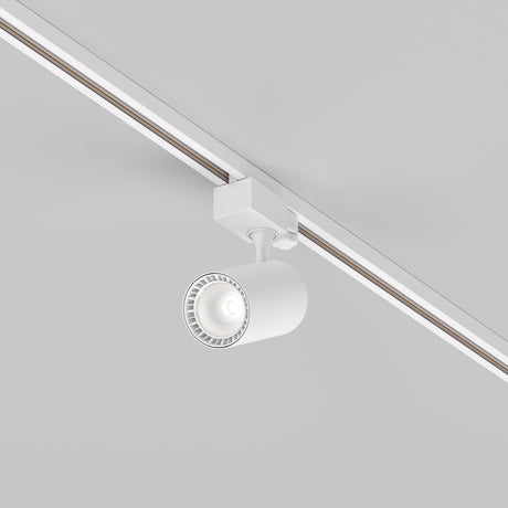 The Vuoro S 3-Circuit Trinity Track LED Spotlight 10W 4000K in white is mounted on a track, illuminating the light gray ceiling with precise directional control.