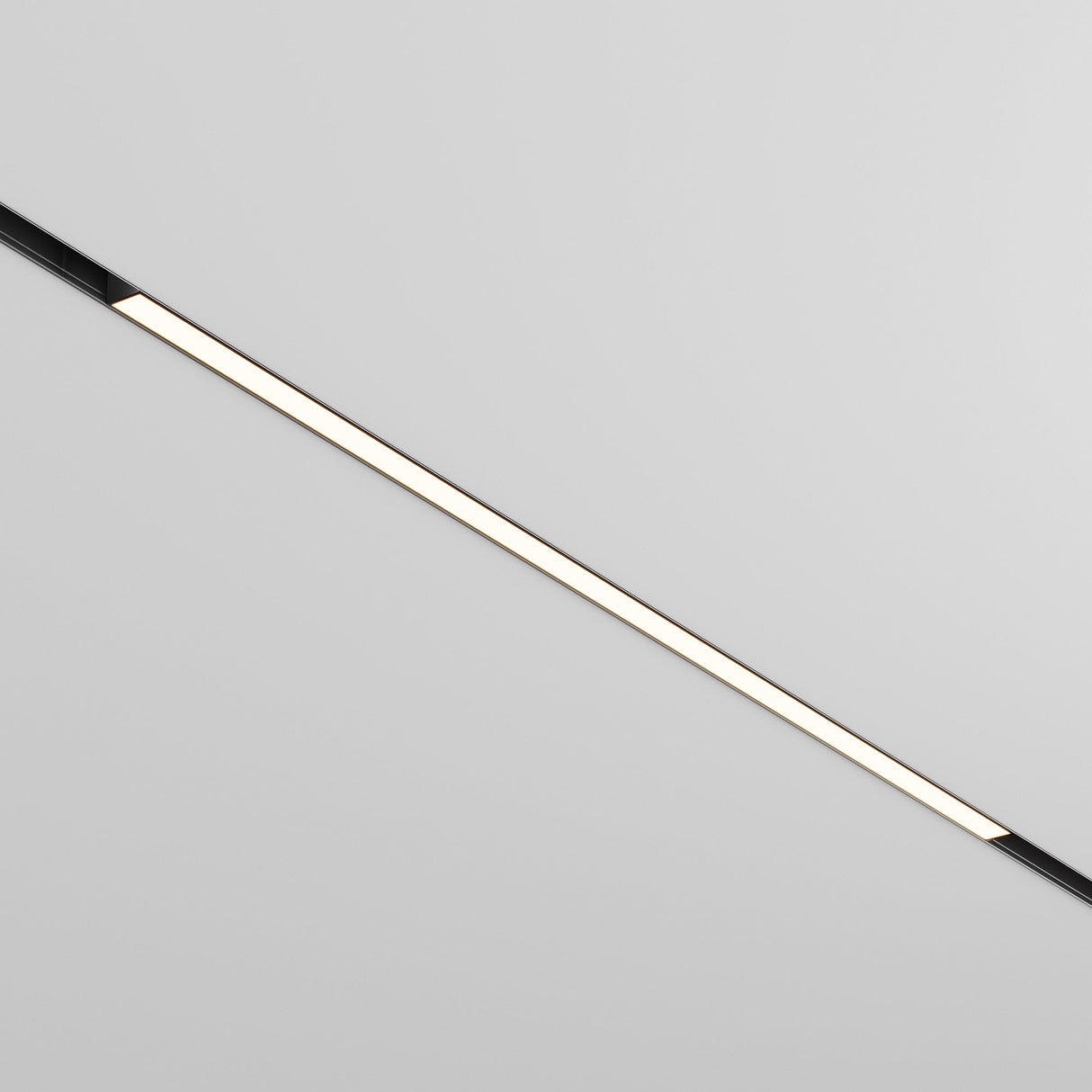 The Basis DALI CCT LED Dimmable Linear Track Light for Magnetic Exility, 30W 2700-6000K with sleek black trim, is mounted on a plain white ceiling. When turned on, it emits a soft glow along its length, enhancing the minimalist modern decor of the space.