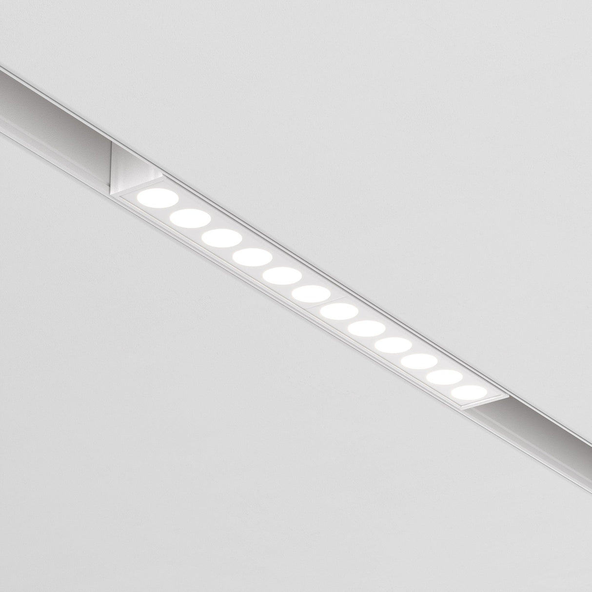 The Points LED Linear Track Light for Magnetic Exility 12W 4000K features a sleek modern design with thirteen evenly spaced round bulbs set against a white background, providing energy-efficient lighting.