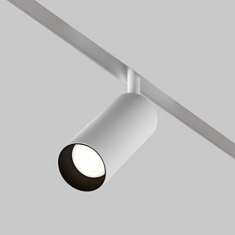 The Focus LED Magnetic Exility Track Spotlight 12W 4000K - White is mounted on a horizontal rail against a simple gray background, featuring sleek, cylindrical white housing. It emits natural white light with a high color rendering index through its circular opening, casting a bright glow.