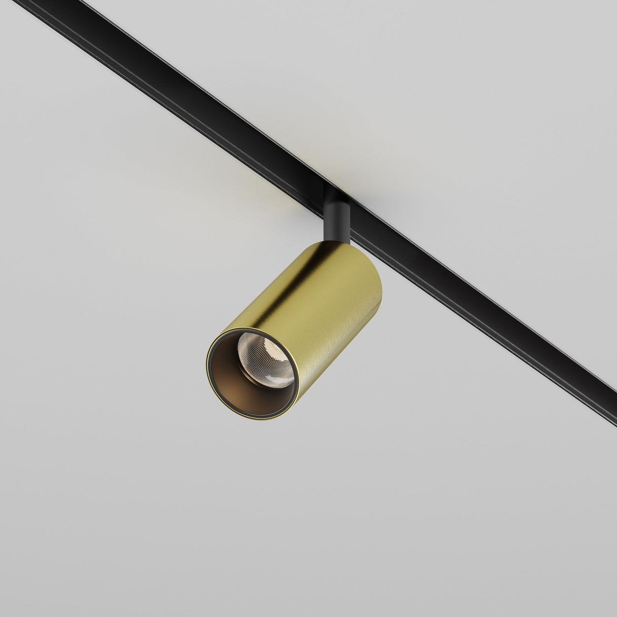 The Focus LED Magnetic Exility Track Spotlight 5W 3000K in Black & Brass is mounted on a sleek black track against a plain white ceiling. With high CRI lighting, the minimalist and elegant design complements contemporary interiors perfectly.
