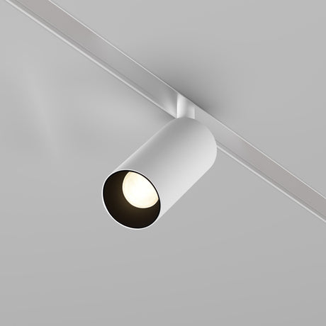 The Focus LED DALI CCT Magnetic Exility Track Spotlight 5W 2700-6000K in white, featuring a minimalist design, casts light downward from a plain light gray ceiling. It emphasizes modernity and seamlessly integrates with the magnetic track system.