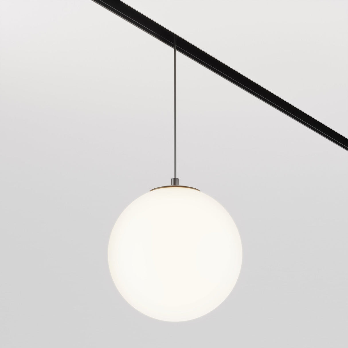 The Luna LED Exility Magnetic Track Pendant Light 5W 4000K - Black hangs elegantly, showcasing a smooth white spherical shade on a sleek black rod against a light gray background. Its minimalistic design highlights simplicity and energy efficiency.