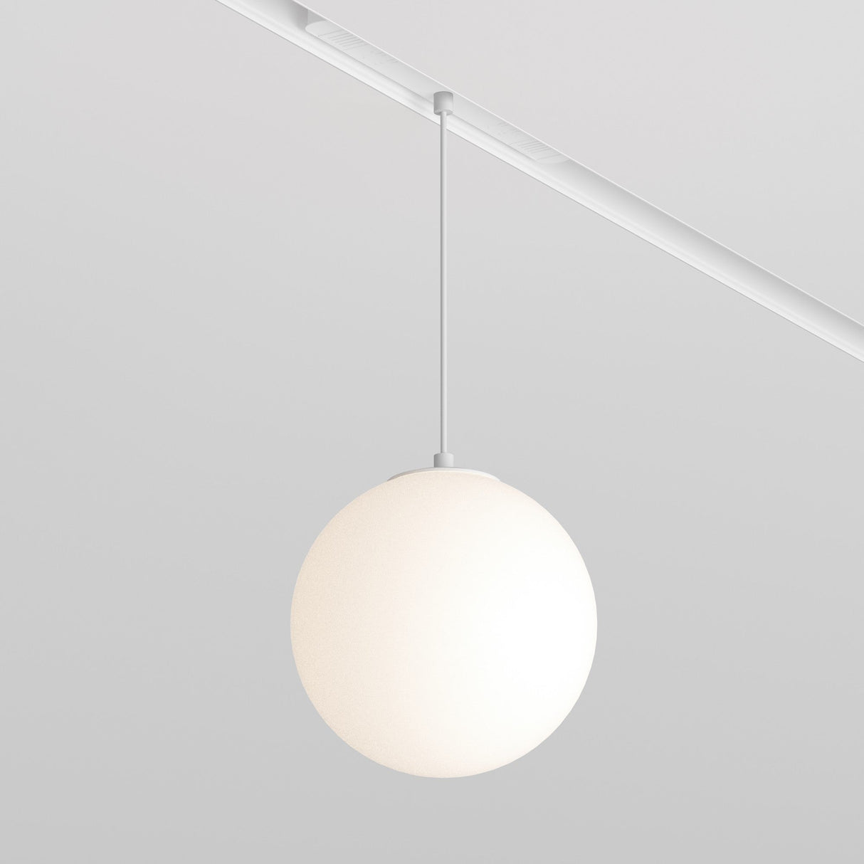 A Luna LED Exility Magnetic Track Pendant Light 5W 4000K - White elegantly hangs from a sleek track on a white ceiling. Its smooth white shade adds sophistication, while the light gray background complements its minimalist, modern style and energy-efficient lighting.