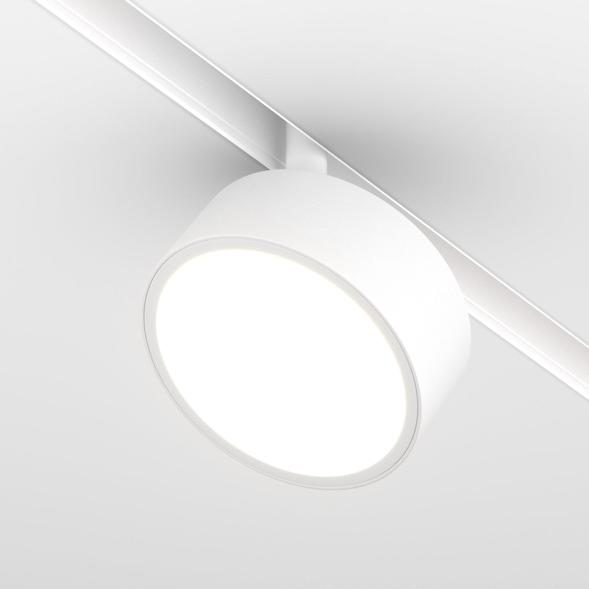 The Rado LED Magnetic Exility Track Spotlight is a modern white ceiling light fixture with a round, flat design attached to a ceiling track. It emits an 18W bright 4000K glow, offering versatile lighting options for a minimalist and clean aesthetic.