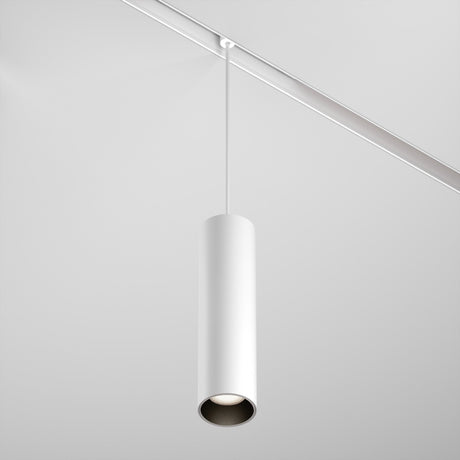 The Focus LED Exility Magnetic Track Pendant Light 12W 4000K - White, with its sleek cylindrical design, hangs elegantly from a white ceiling on a thin wire. This minimalist fixture embodies energy-efficient lighting with its clean, modern look.