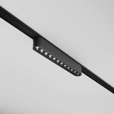 The Points LED Linear Track Light for Magnetic Tracks Radity, 12W and 4000K in black, is mounted on a gray ceiling. With nine individual lights, it casts a modern, minimalist appearance.
