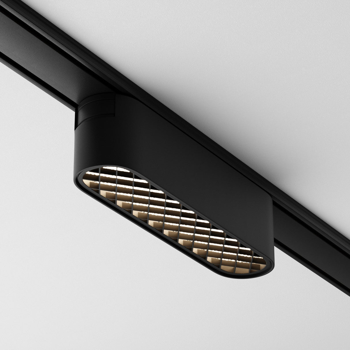 A Basis Grid LED Linear Track Light for Magnetic Tracks Radity 6W 4000K in black is mounted on a white ceiling. Featuring a grid pattern underneath, this modern light reveals warm bulbs and embodies a minimalist aesthetic while offering efficient lighting.