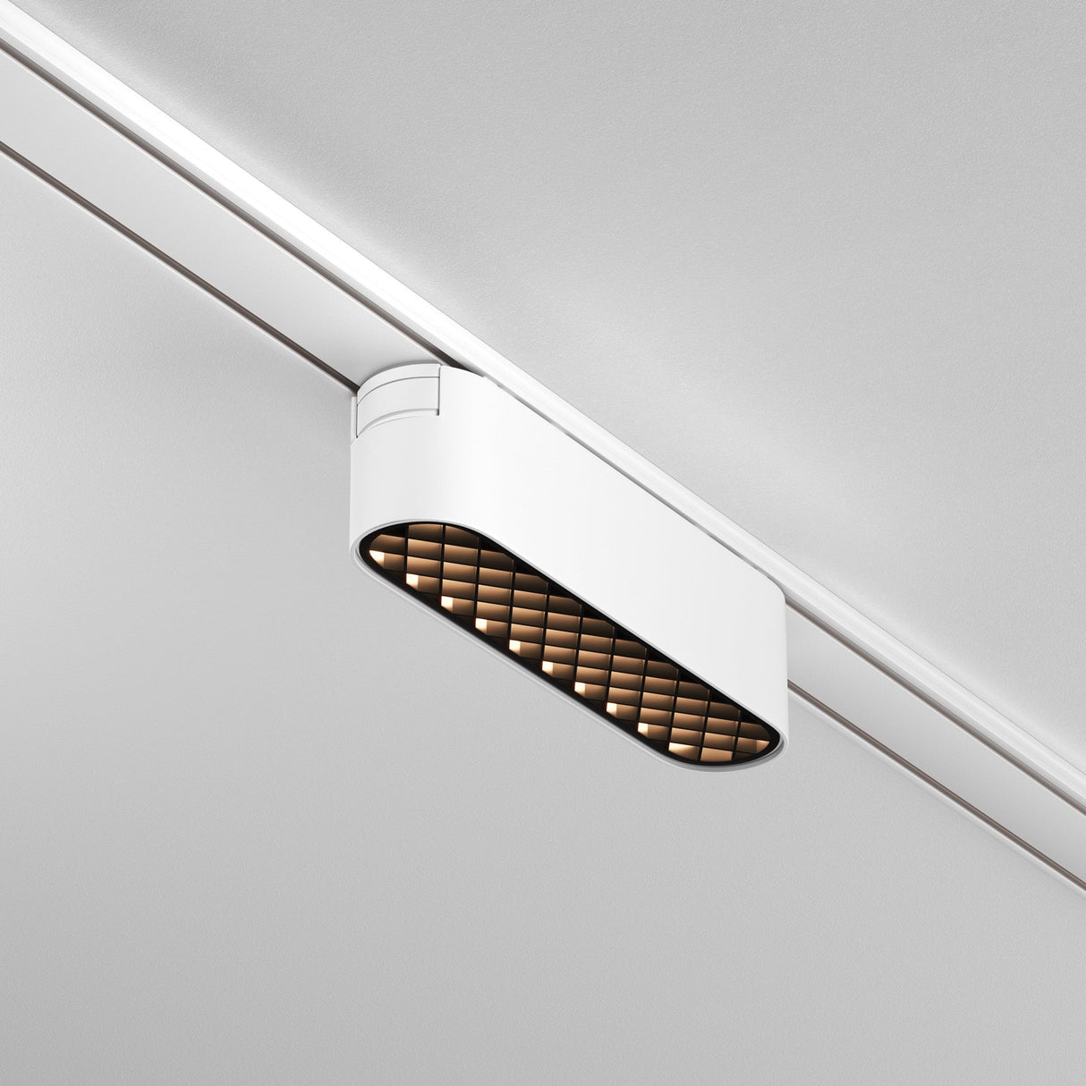 The Basis Grid LED Linear Track Light by Radity is a modern 6W fixture with a white rectangular casing, adjustable lighting, and grid patterns. It seamlessly integrates into magnetic tracks with its minimalist design.