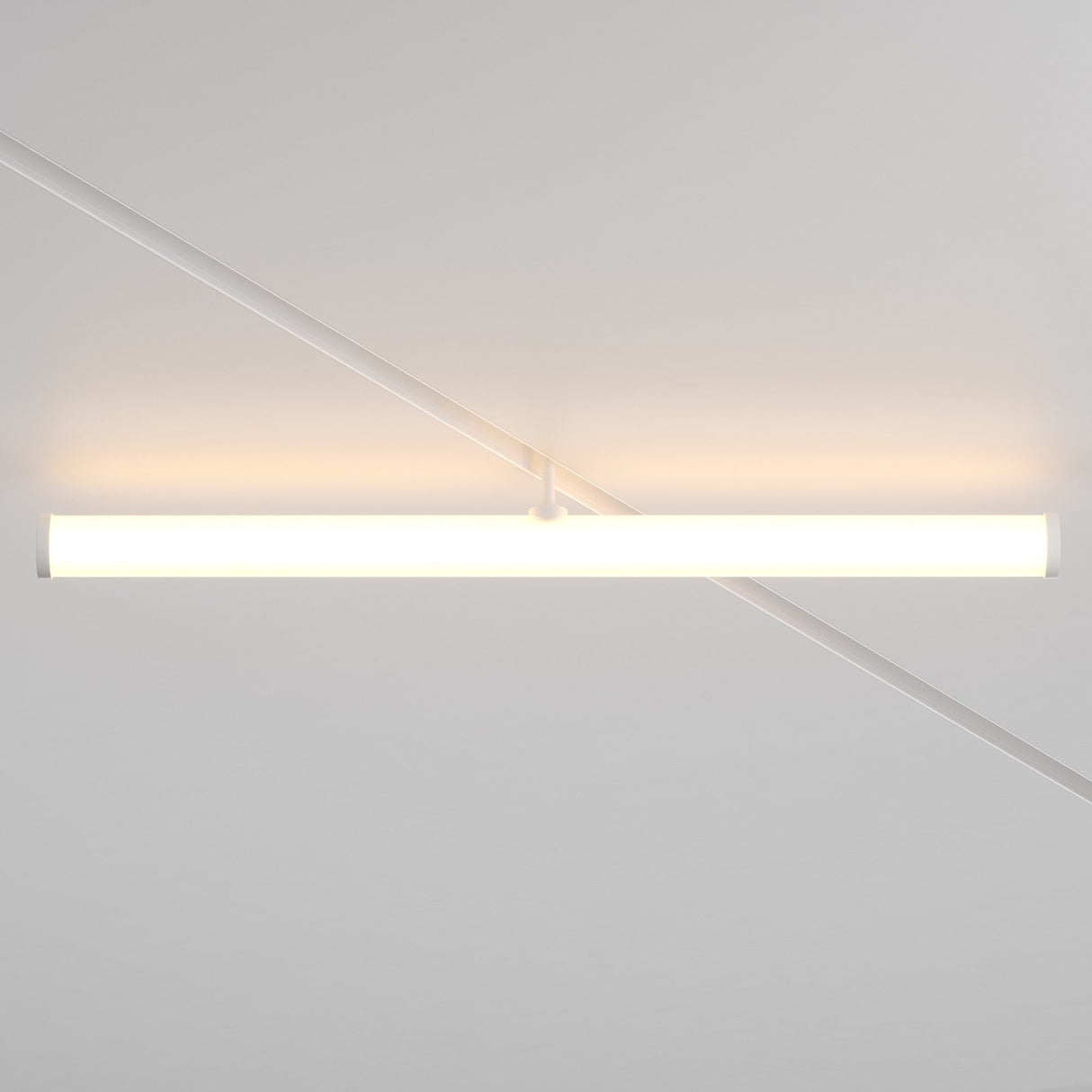 The Larc LED Rotating Linear Track Light for Magnetic Exility (25W, 3000K) emits a warm glow from the white ceiling, casting soft shadows and diagonal lines across the surface with its minimalist cylindrical design.