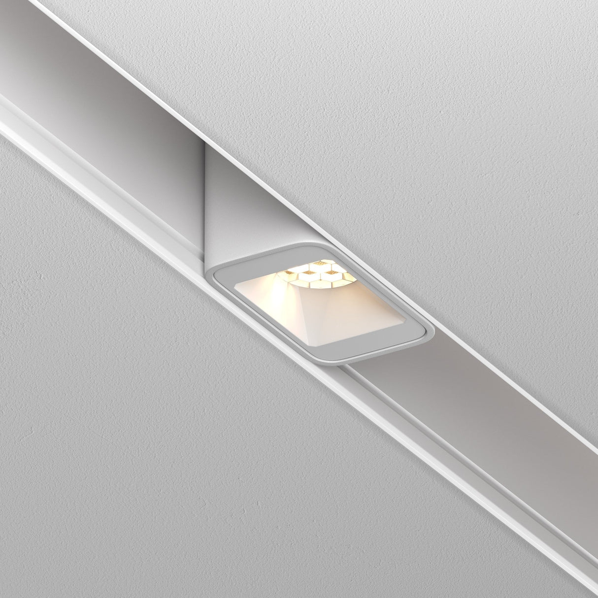 The Points S LED Magnetic Exility Track Downlight 2W 3000K in white is installed in the ceiling, offering a sleek recessed look. Its modern, minimalist design features a unique square opening with a honeycomb filter that provides bright, focused illumination.