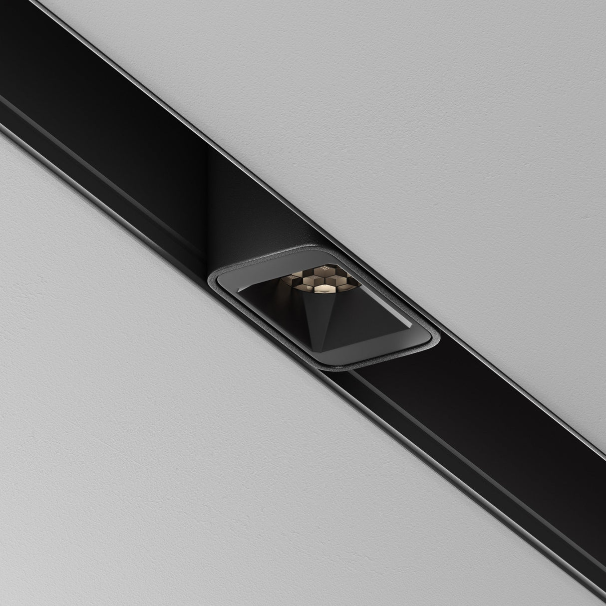 A close-up of a modern recessed ceiling light showcases the Points S LED Magnetic Exility Track Downlight 2W 4000K - Black. It features small circular bulbs emitting cool 4000K light, set in a smooth white ceiling for a sleek and minimalist design.