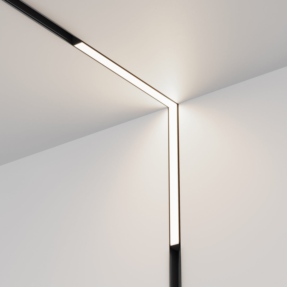 The Basis LED 90° Linear Track Light for Magnetic Exility (24W, 4000K) in black creates a modern geometric aesthetic with its sleek design, casting cool white light and soft glow against the crisp white walls and ceiling corners.