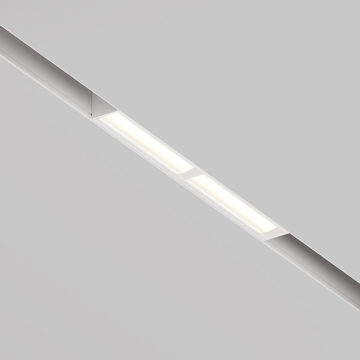 The ceiling boasts the Parete CCT LED Dimmable Linear Track Lights for Magnetic Exility in white, 12W. Emitting a soft glow on the smooth, light gray surface, its adjustable color temperature (2700-6000K) enhances ambiance with versatile lighting options to suit any mood.