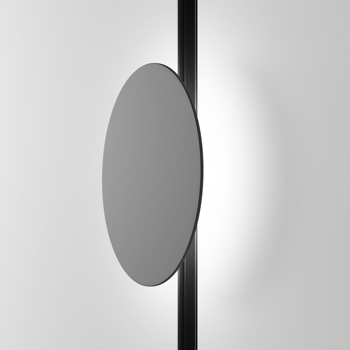 A minimalist circular mirror with an integrated Relax CCT LED Dimmable Magnetic Exility Track Wall/Ceiling Light (5W, 2700-6000K) in a vertical black strip offers adjustable color temperature, enhancing modern aesthetics against a plain gray background.