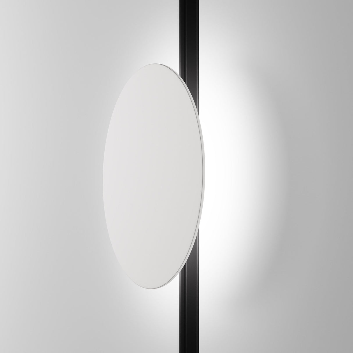 The minimalist image showcases the Relax CCT LED Dimmable Magnetic Exility Track Light, featuring a circular white disk aligned with a vertical black rod. The backdrops gradient from white to gray enhances its contemporary aesthetic, perfect for modern interiors.