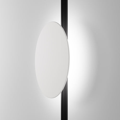 The minimalist image showcases the Relax CCT LED Dimmable Magnetic Exility Track Light, featuring a circular white disk aligned with a vertical black rod. The backdrops gradient from white to gray enhances its contemporary aesthetic, perfect for modern interiors.