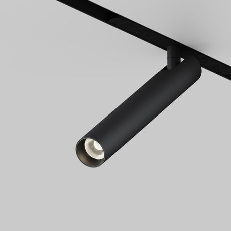 The Focus T LED Magnetic Exility Track Spotlight 6W 3000K - Black offers a sleek, modern cylindrical design with energy-efficient LED lighting. It features elegant magnetic installation on a track set against a light gray background.