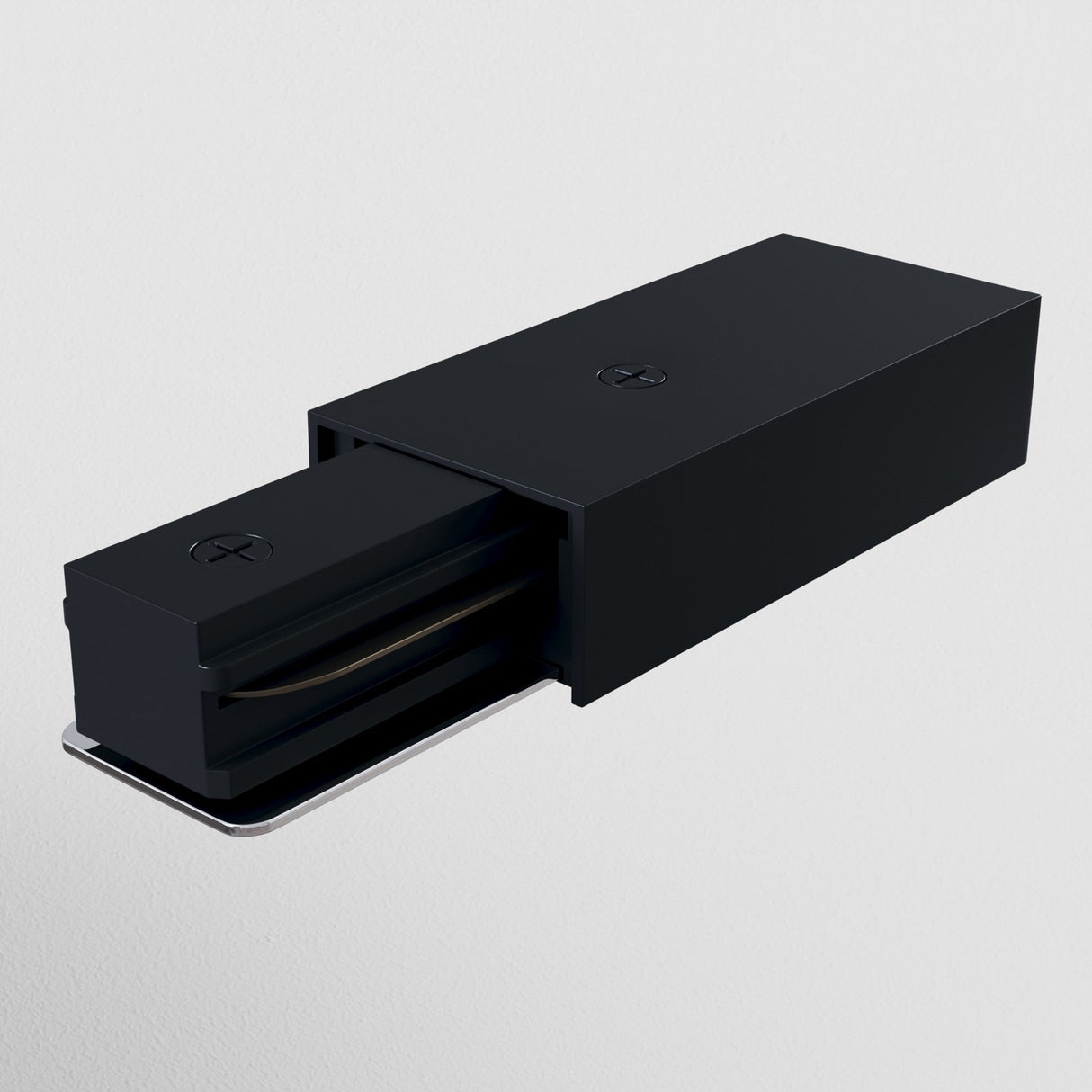 A black wall-mounted light fixture with a rectangular box design features the Unity Single Phase Track Power Feed. An extendable section is partially exposed, revealing the light source against a plain white background, exuding modern elegance.