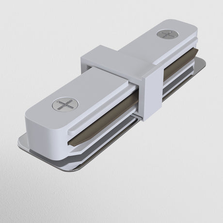 A sleek, modern Unity Single Phase Surface-Mounted Track Straight Connector in white with a metallic finish and cross-shaped screw details. Featuring a rectangular base and minimalist design, it pairs effortlessly with seamless lighting connections, mounted on a flat surface.
