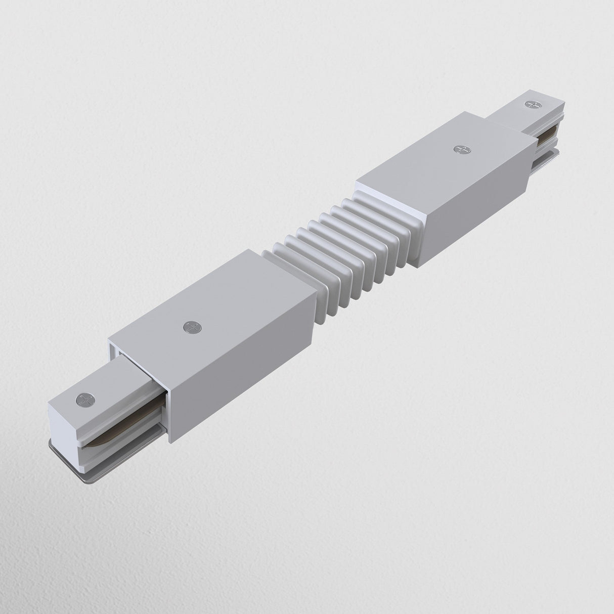 On a plain white background, an accordion-like metal object with segmented grooves and two rectangular end extensions is displayed. It resembles the Unity Single Phase Surface-Mounted Track Flexible Connector - White, appearing as an industrial component.