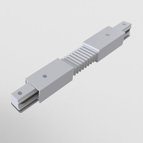 On a plain white background, an accordion-like metal object with segmented grooves and two rectangular end extensions is displayed. It resembles the Unity Single Phase Surface-Mounted Track Flexible Connector - White, appearing as an industrial component.