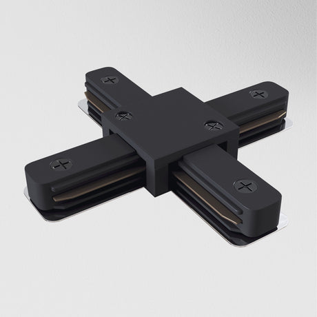The Unity Single Phase Surface-Mounted Track X-Connector in black features an X shape with four arms on a light gray background, each with visible screws and metal contacts, suggesting its a multi-directional lighting connector.