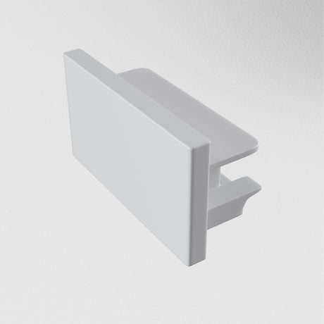 A Unity Single Phase Surface-Mounted Track End Cap in silver, featuring a rectangular metal bracket with a flat top and hook-like structure underneath, is displayed against a plain white background.