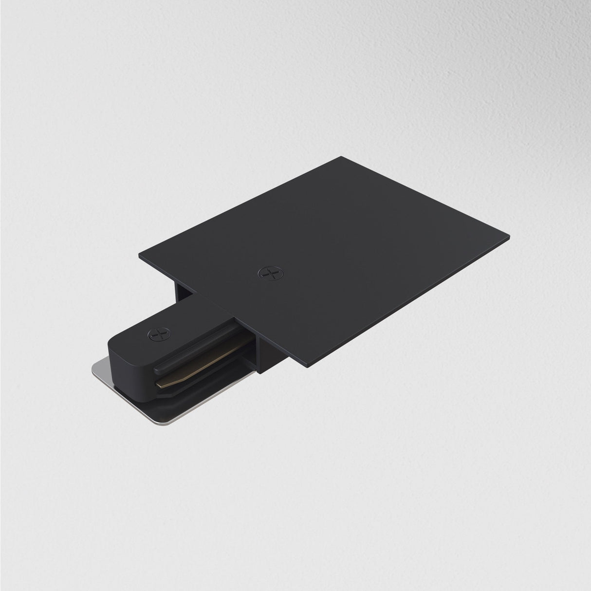 A Unity Tracks Power Feed - Black, featuring a sleek rectangular design and a protruding metal component, is mounted on a plain white wall.