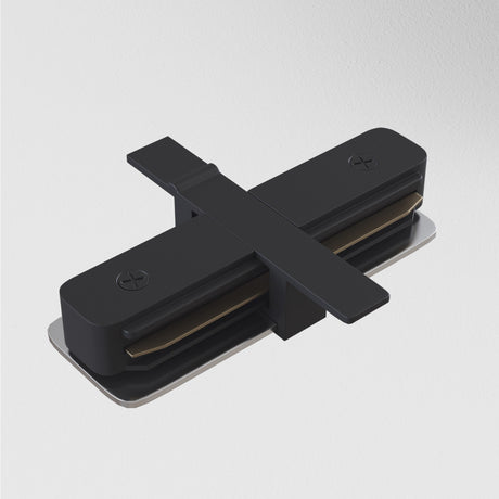 Close-up of the Unity Tracks Recessed Straight Connector - Black on a smooth white background. The design features two sleek cylindrical parts with embedded screws and a connecting bar, showcasing its aluminium construction that embodies both strength and modern elegance.