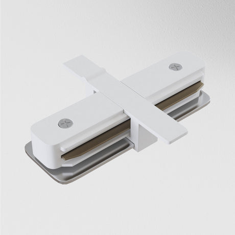 The Unity Tracks Recessed Straight Connector in white features a step-like height adjustment design and two intersecting rectangular arms with visible screws, perfectly complementing recessed track lighting on an off-white background.