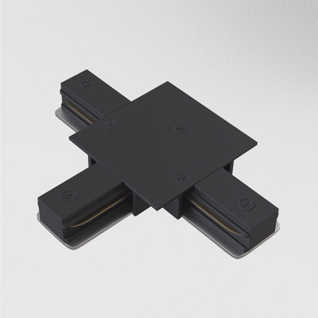 A black Unity Tracks Recessed T-Connector, square-shaped with a flat top and four extending aluminum arms featuring visible screws, is set against a plain white background.